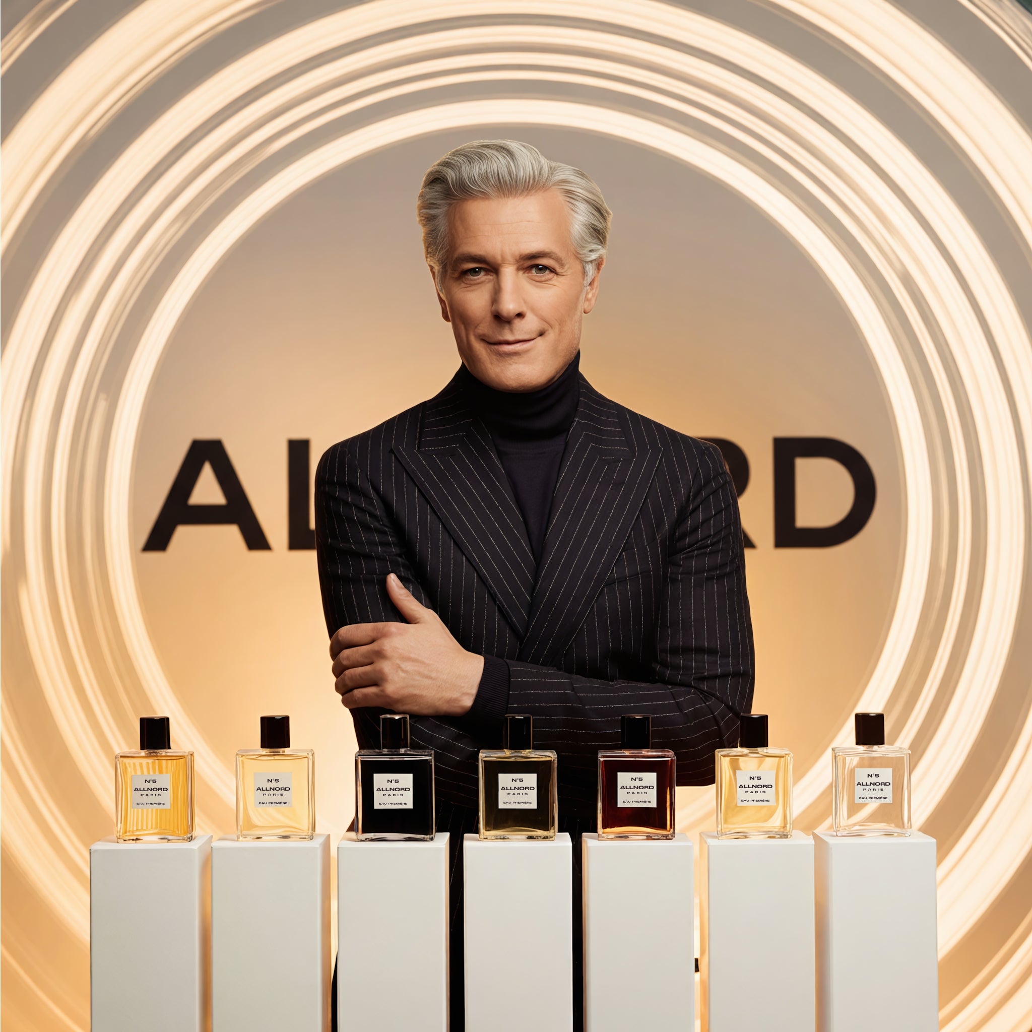 Elegant grey‑haired Allnord founder in a dark pinstripe suit stands behind six Allnord perfume bottles displayed on white plinths, framed by glowing golden light rings and a soft beige backdrop with the brand logo.