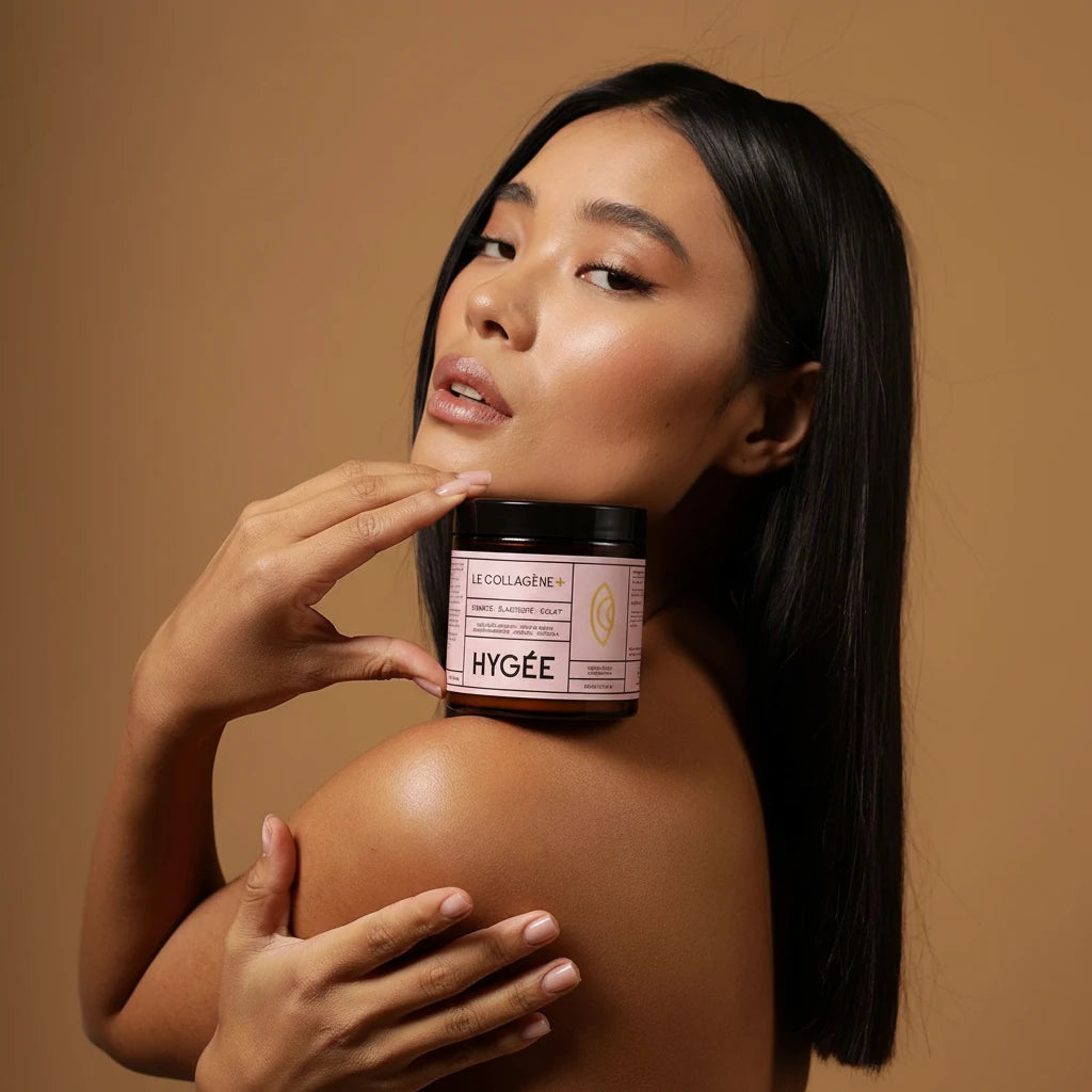 Model with flawless skin and bare shoulders holding the HYGÉE Le Collagène+ marine collagen supplement jar near her face.