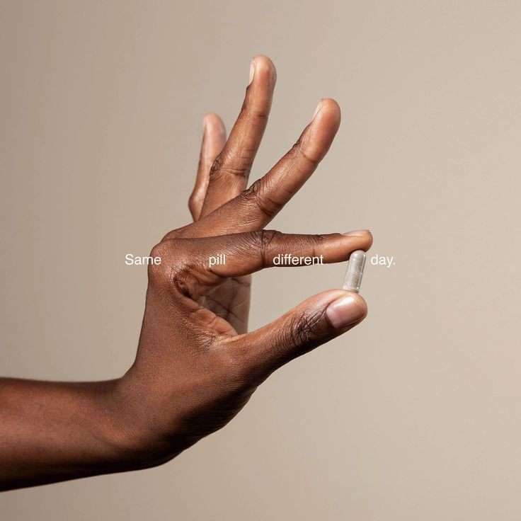 A close-up of a hand holding a single Hygée La Chevelure capsule, with the text "Same pill different day" overlaid, poetically illustrating the brand's philosophy of consistent, deliberate daily care.